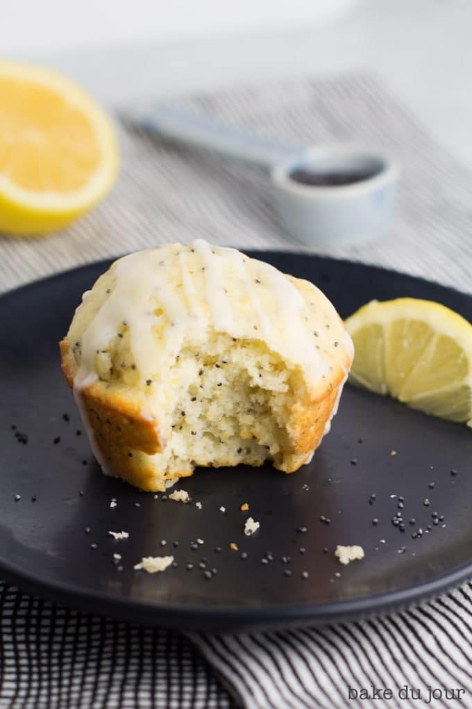 A Lemon Poppy Seed Muffin with a bite taken out of it